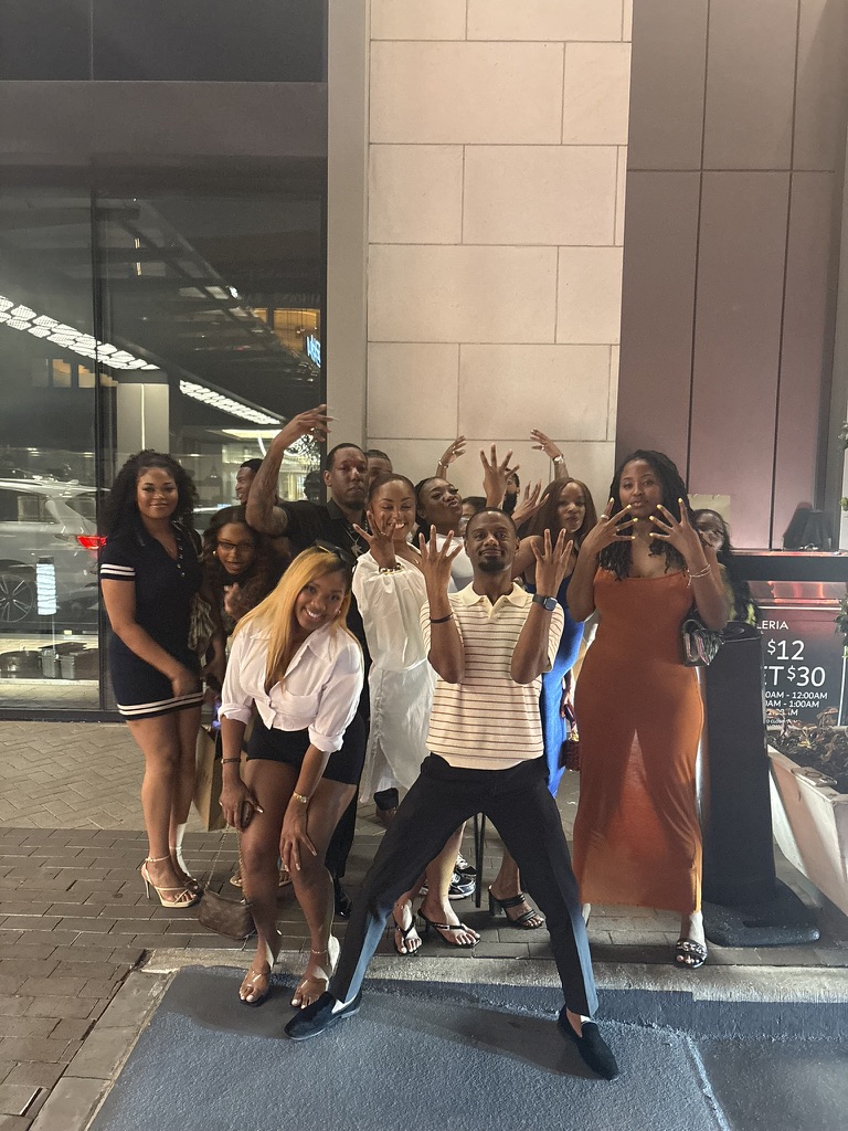 The group posing together on a night out downtown